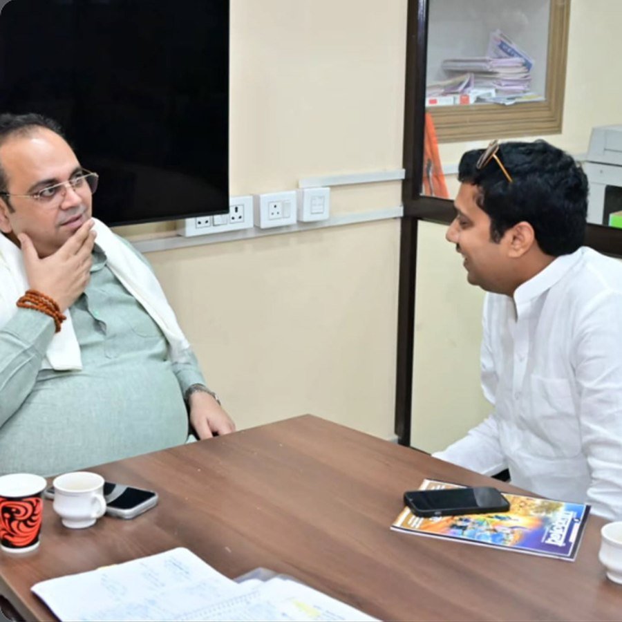 Two individuals seated in a meeting